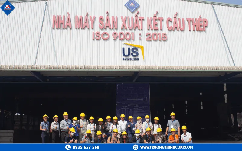 Group photo in front of the factory