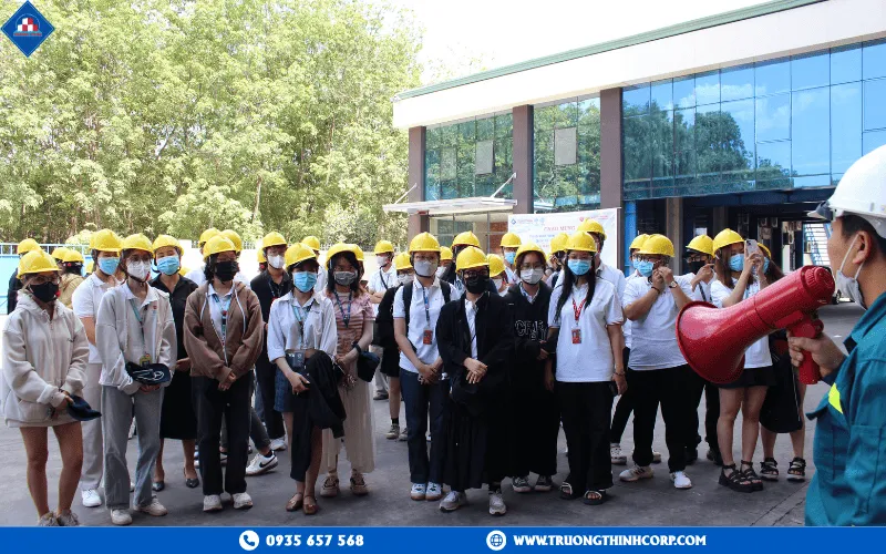 Students were briefed on factory safety regulations before the tour