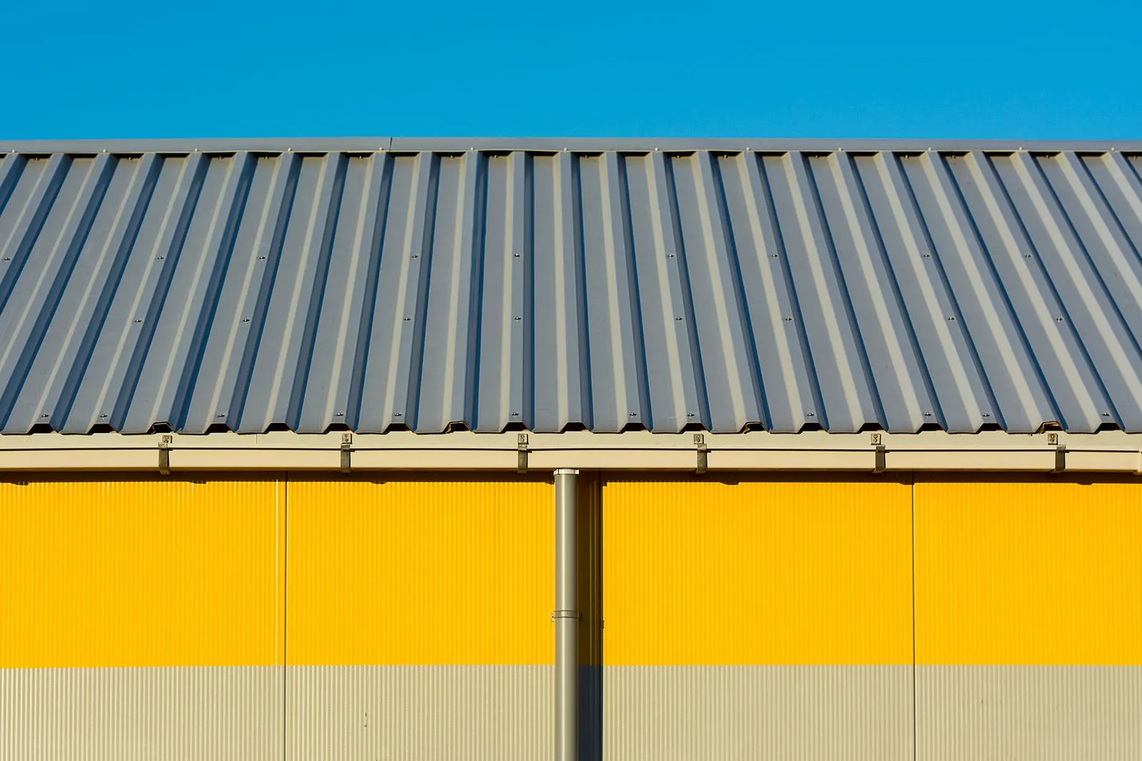 Corrugated steel wall and roof of a pre-engineered building exterior