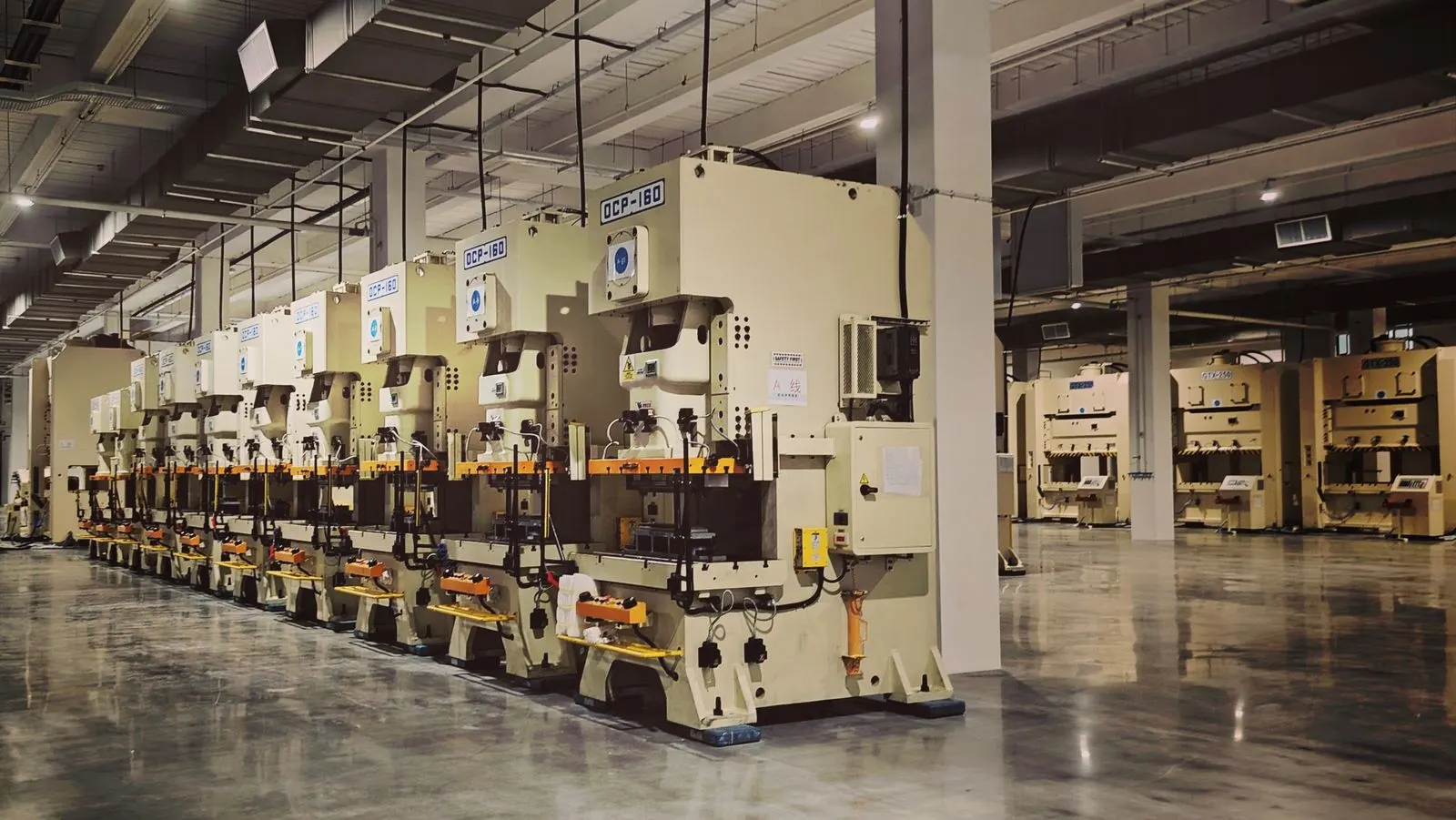 Row of metal-forming machines on an industrial factory floor