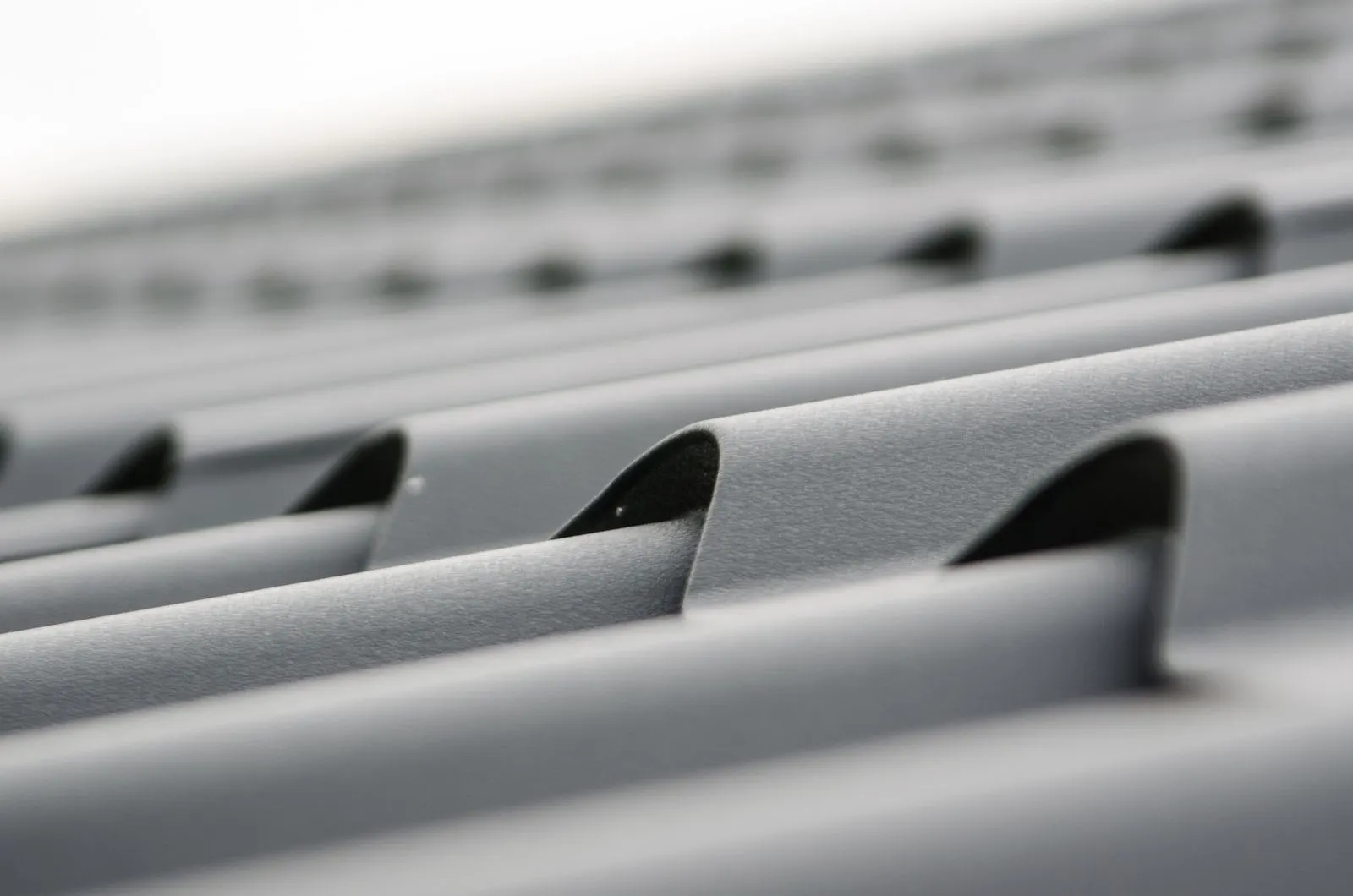 Close-up of corrugated gray steel roof sheet texture