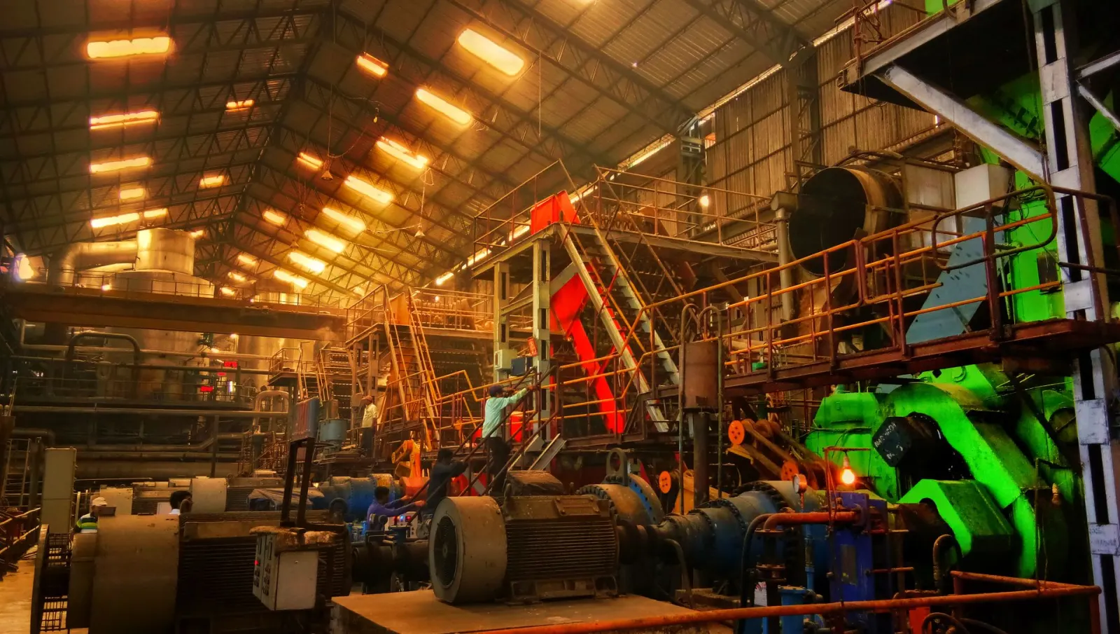 Interior of an industrial fabrication facility with overhead machinery