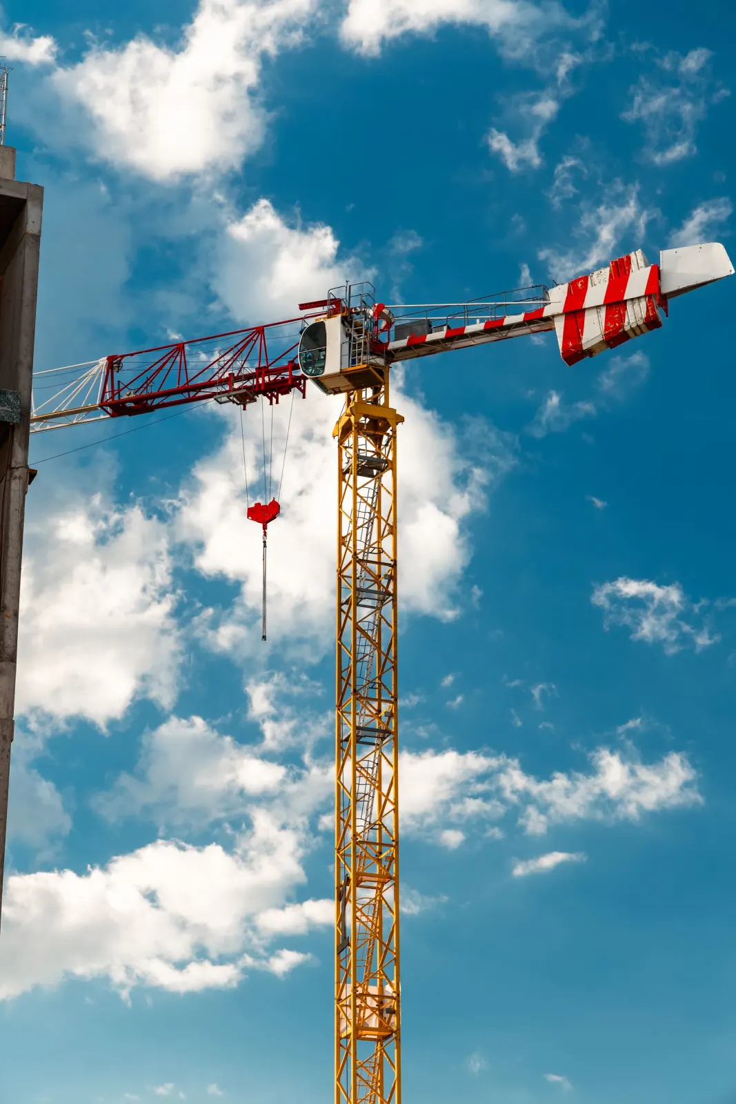 Tower crane against a clear sky at a structural steel construction site