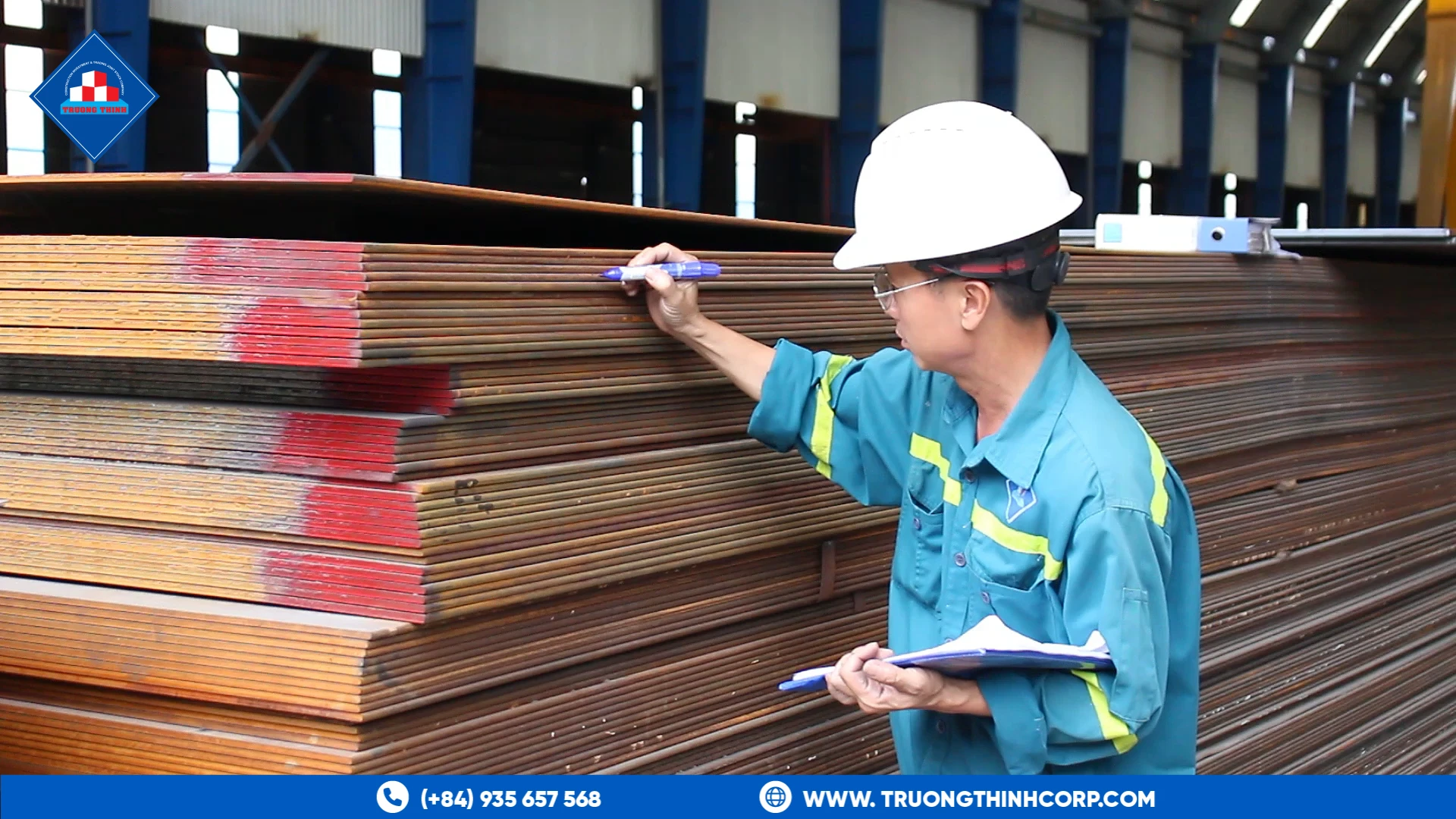 Quality inspector checking steel plate stock at Truong Thinh Corp's factory