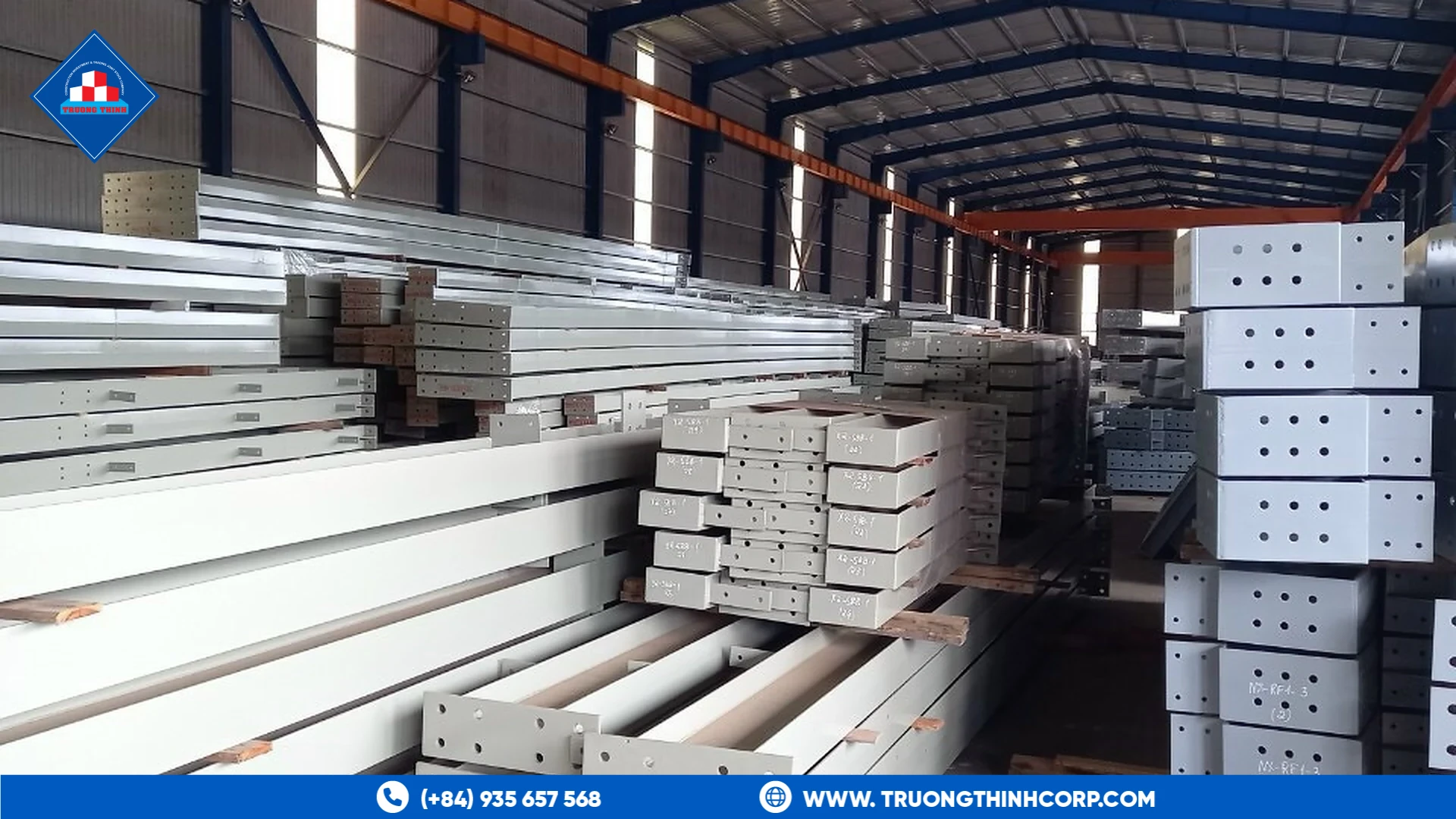 Stacked fabricated white steel sections in storage at Truong Thinh Corp's factory
