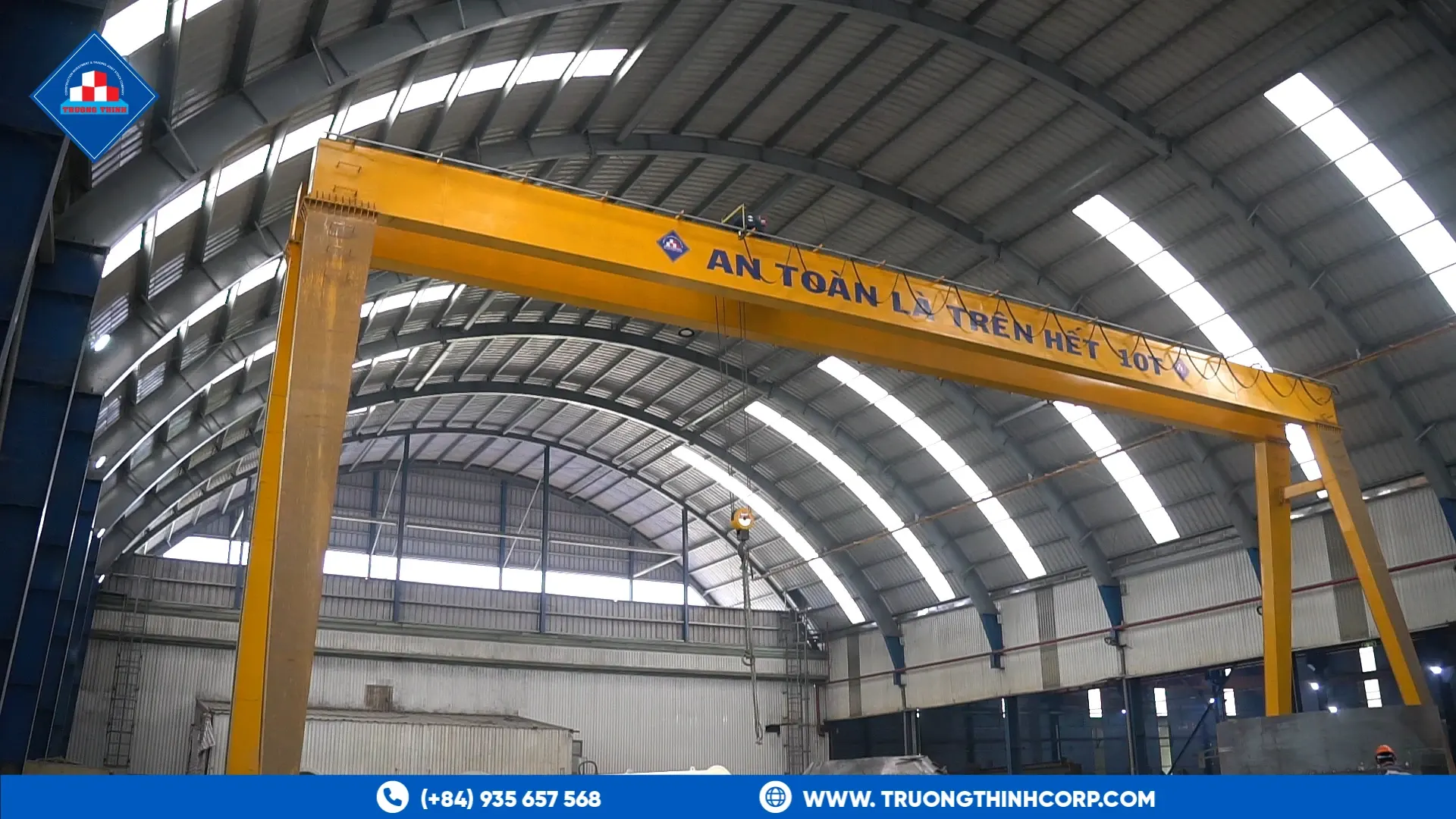Arched steel factory hall with a yellow overhead gantry crane at Truong Thinh Corp