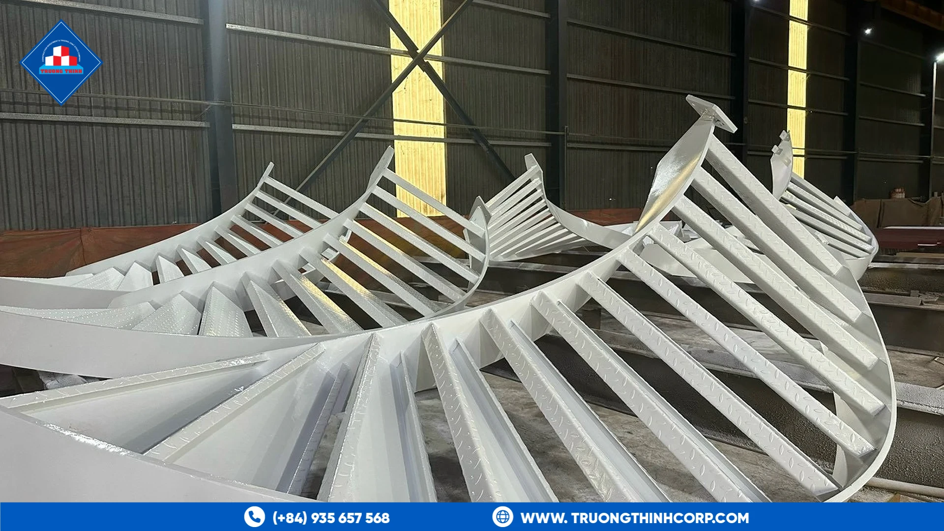 Fabricated curved steel truss ribs painted white at Truong Thinh Corp's factory