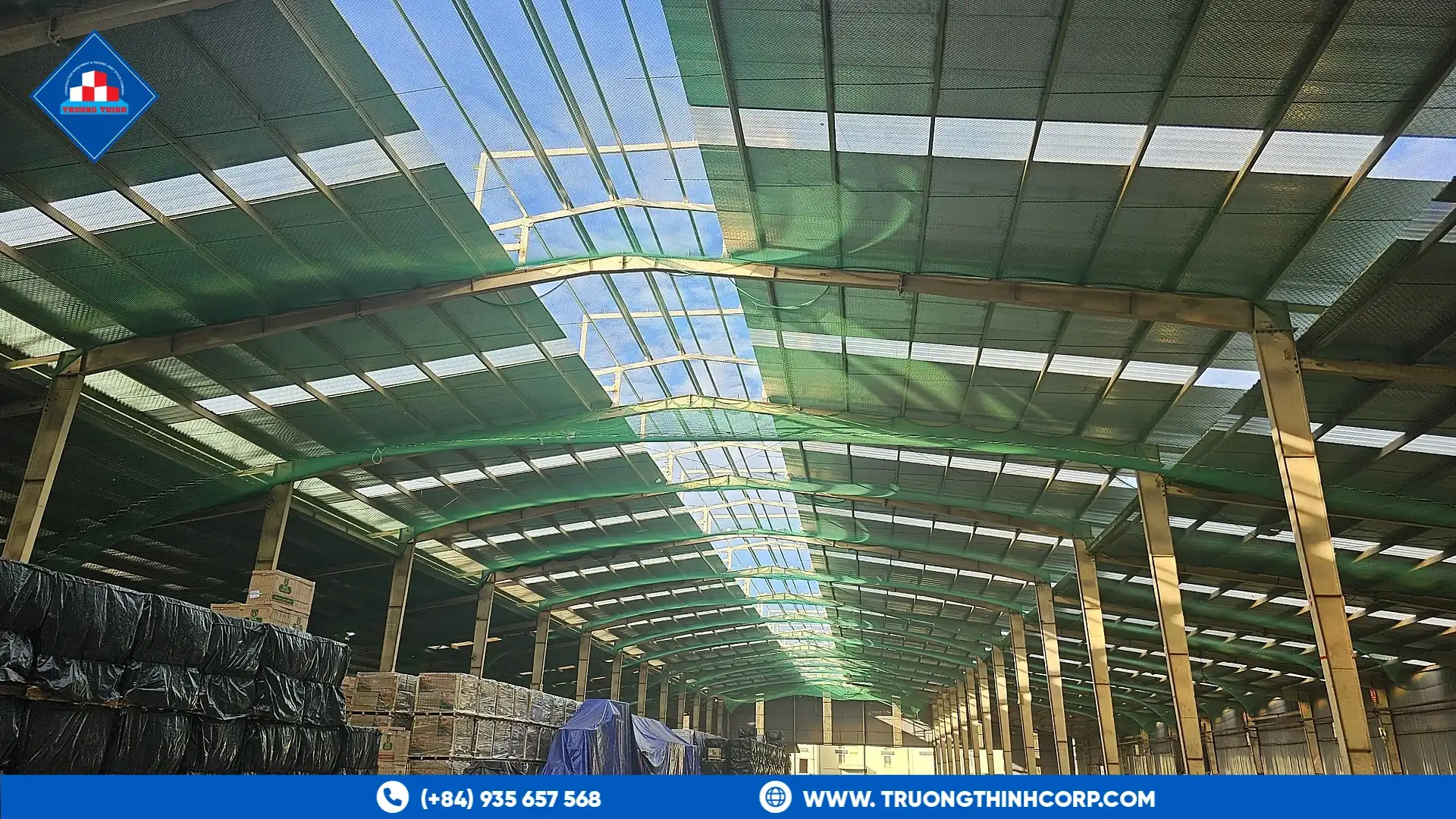 Long steel-frame warehouse bay with storage areas at the Royal House factory project