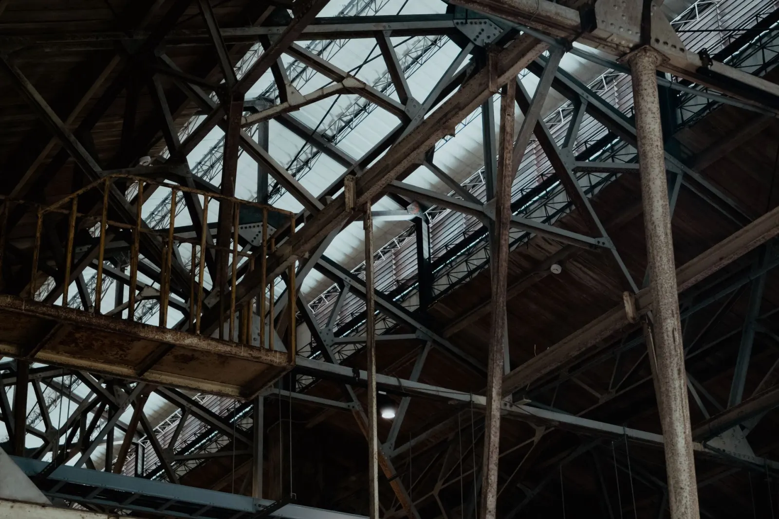 Interior view of exposed steel roof trusses in a large-span industrial building