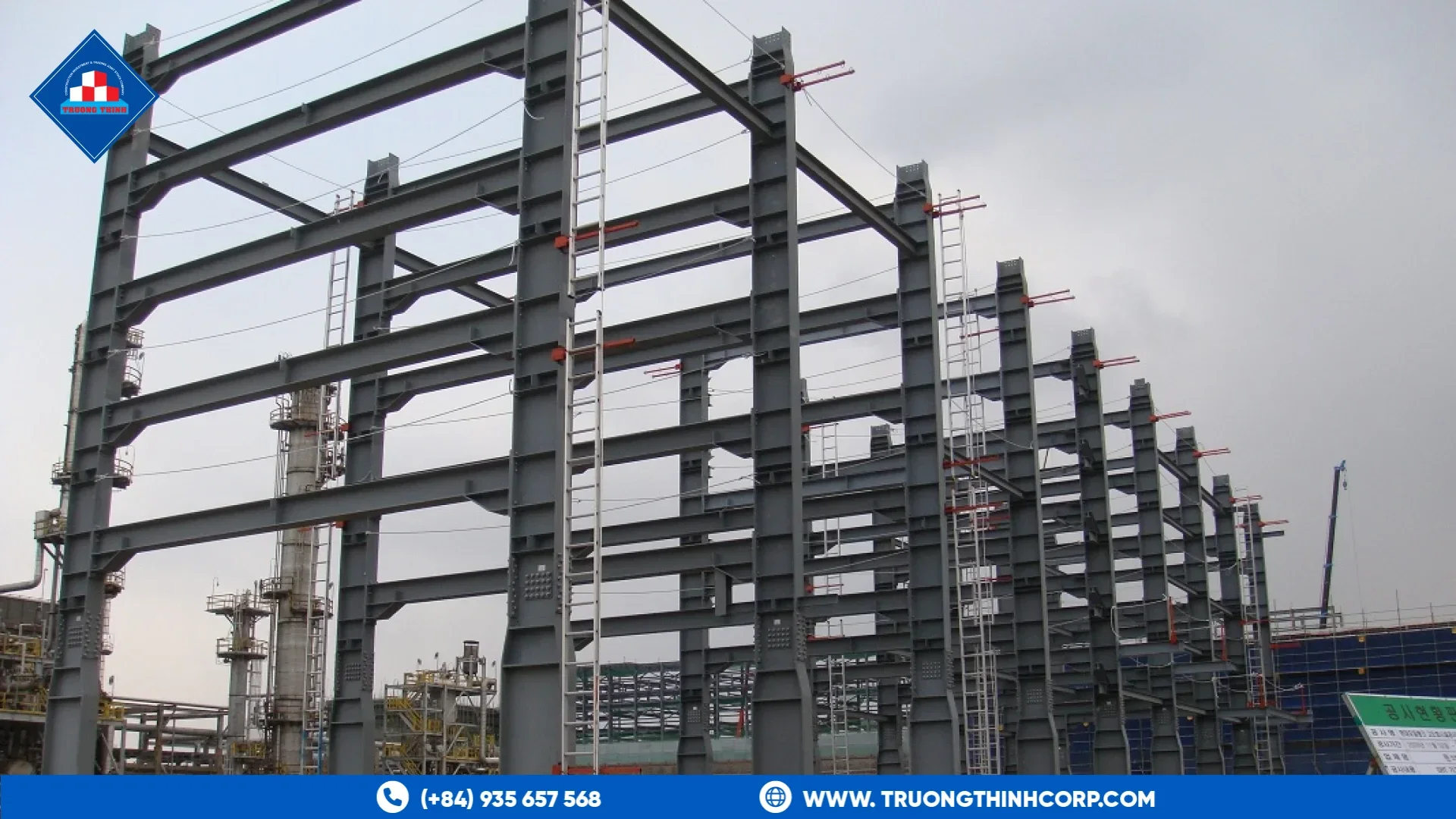 Multi-level steel frame of a pipe rack beside an industrial process plant under construction