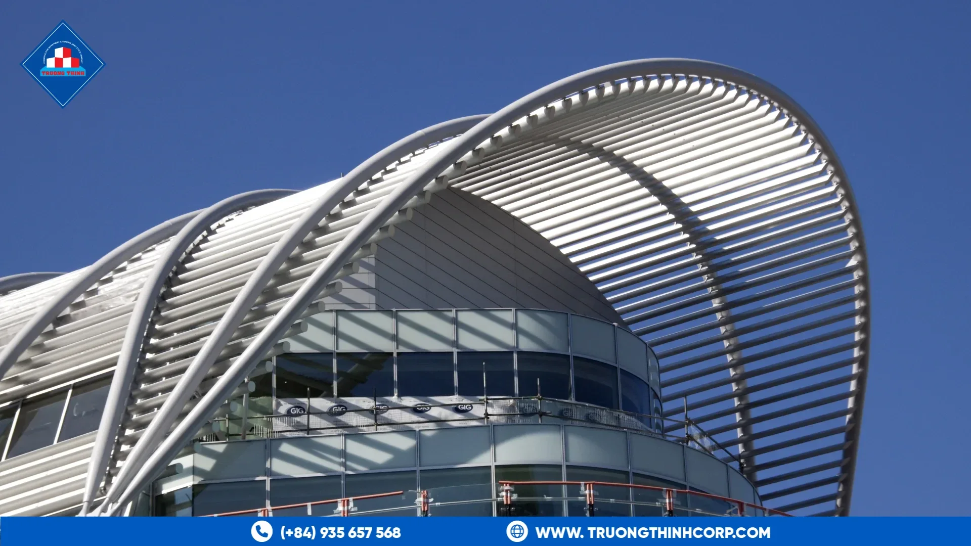 Curved steel canopy roof with slatted metal fins over a glass-fronted building