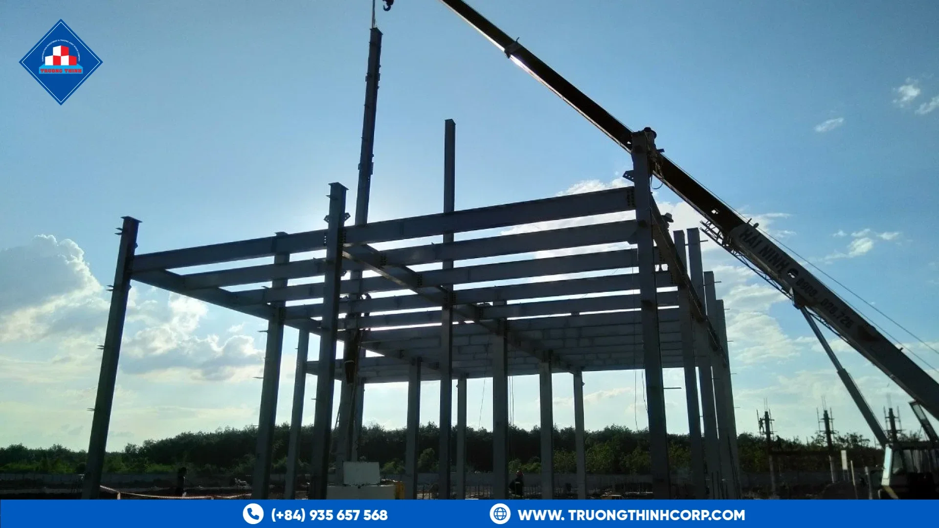 Steel frame of an agro-processing plant being erected with a truck crane at the DABACO feed factory project