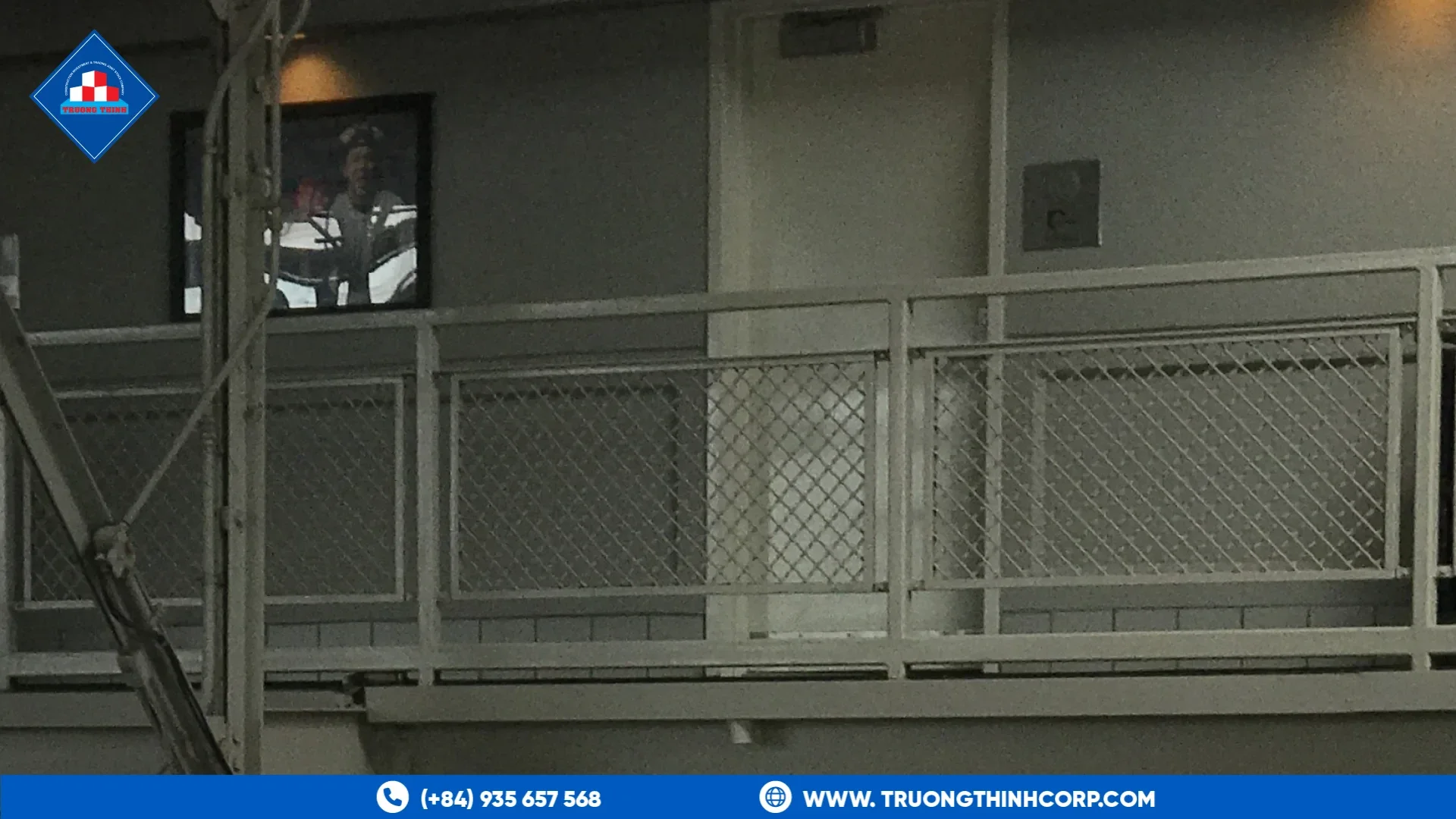 Steel mezzanine walkway with a guard rail and mesh infill above the floor level